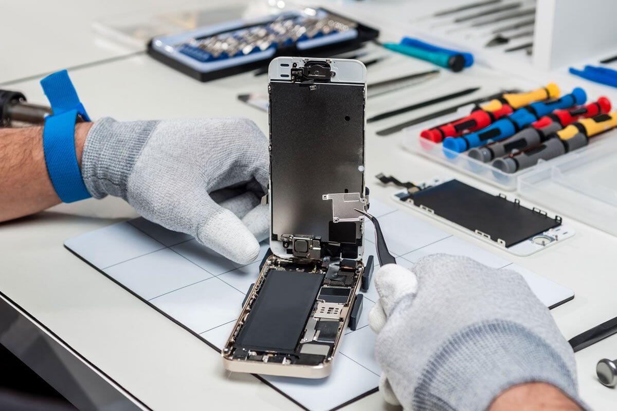 Data recovery engineer working in cleanroom with specialized equipment