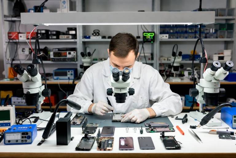 Board-level micro-soldering repair by a Wildfire Data Recovery engineer in the Brisbane lab