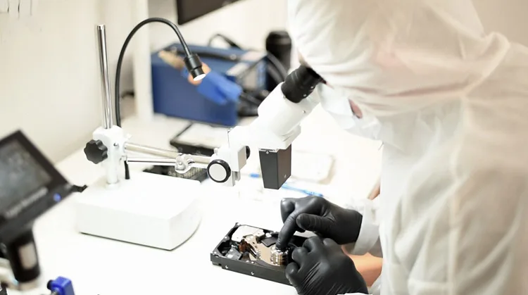 Submit a data recovery job to Wildfire Data Recovery: engineer examining a hard drive under a microscope in our Brisbane lab