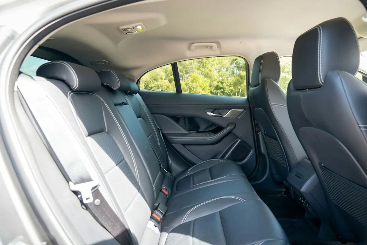 Back seats of a car with seat belts and door pockets, the first places to look when working out how to find an AirTag in my car