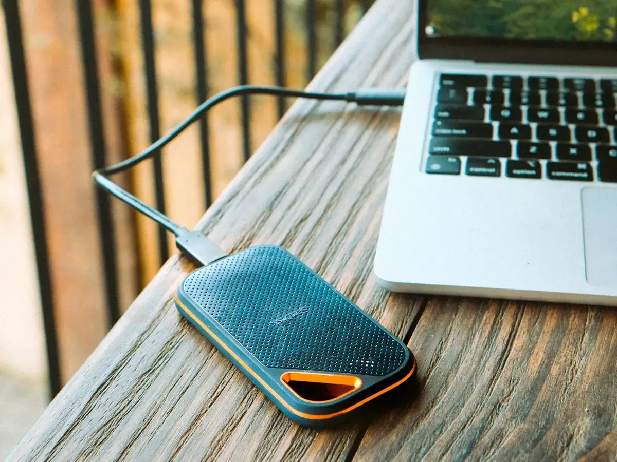 Portable SSD connected to a laptop, the kind of evidence examined in computer forensics for copied company data